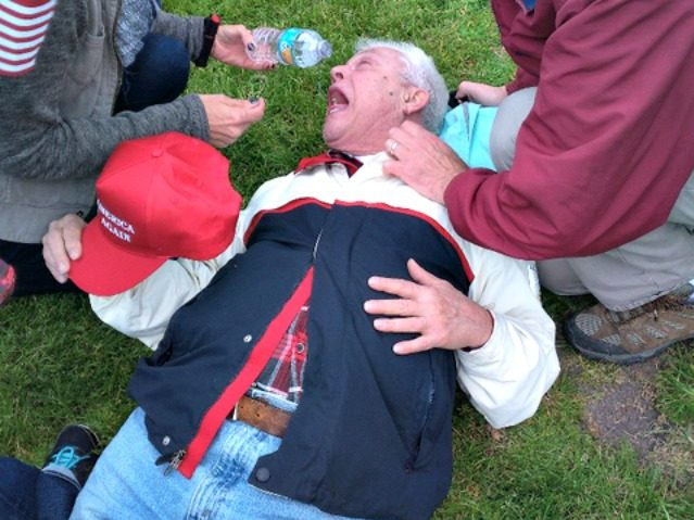 Old Man with a MAGA hat lying on the ground