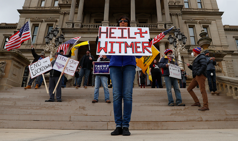 Protestors with anti-Whitmer signs
